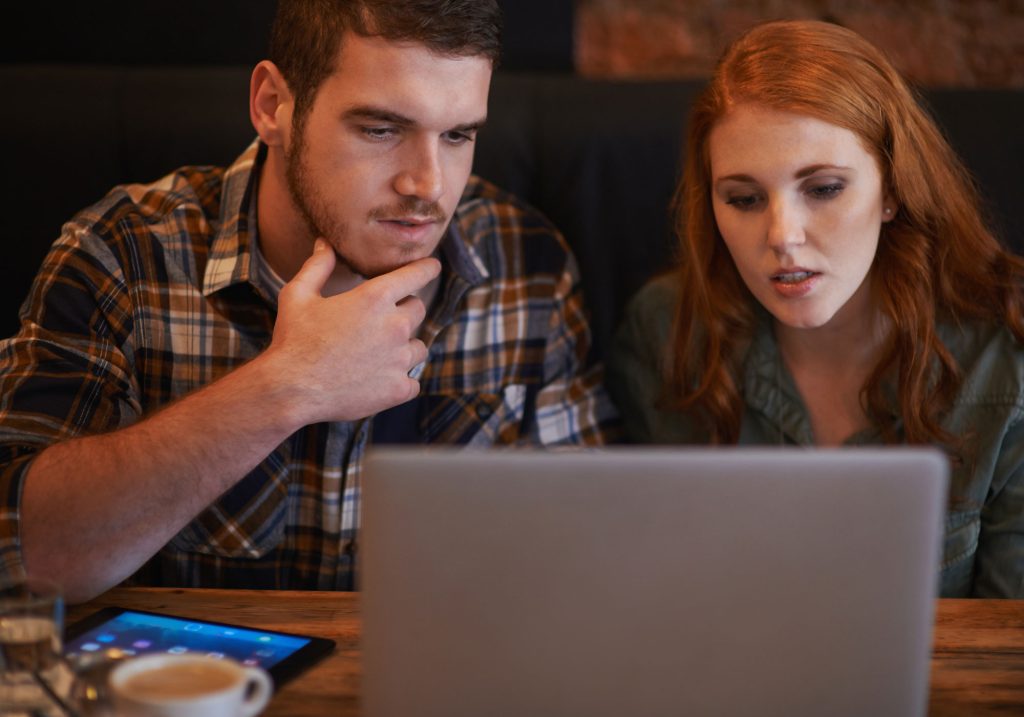 doing little browsing while we wait loving young couple drinking coffee while sitting with laptop cafe web