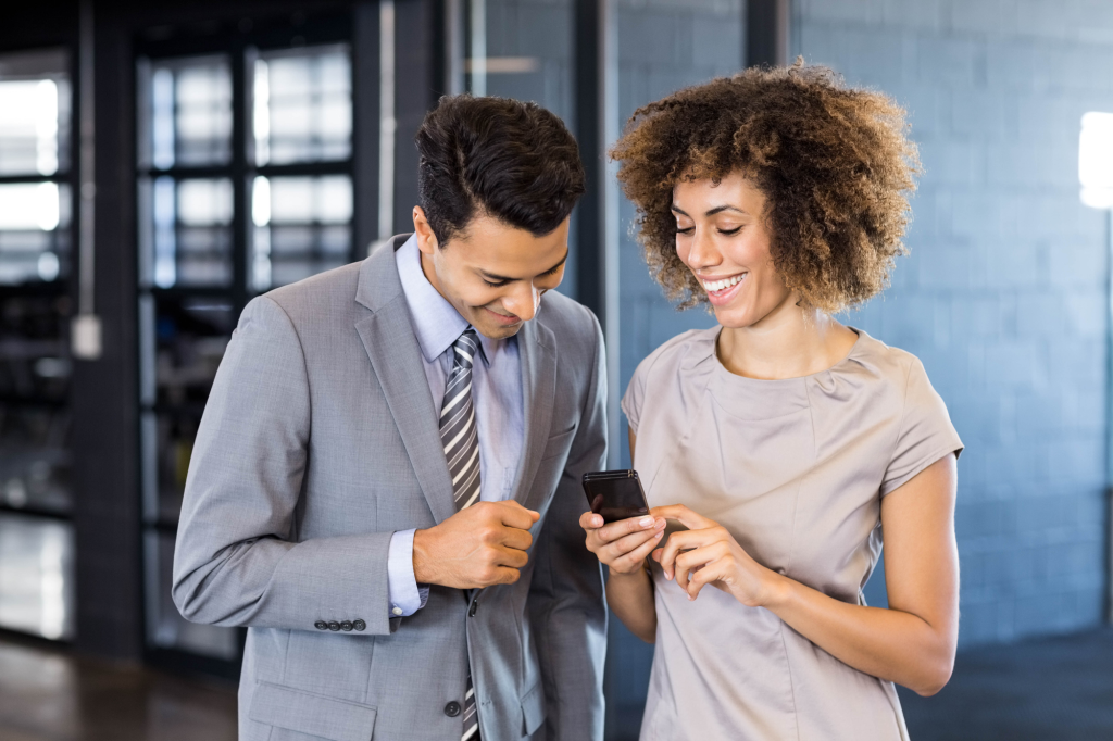 business man talking young woman holding mobile phone office web