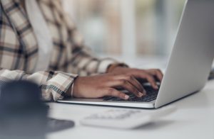 laptop typing woman hands online research startup finance budget management her office desk financial planning working worker employee person computer software web