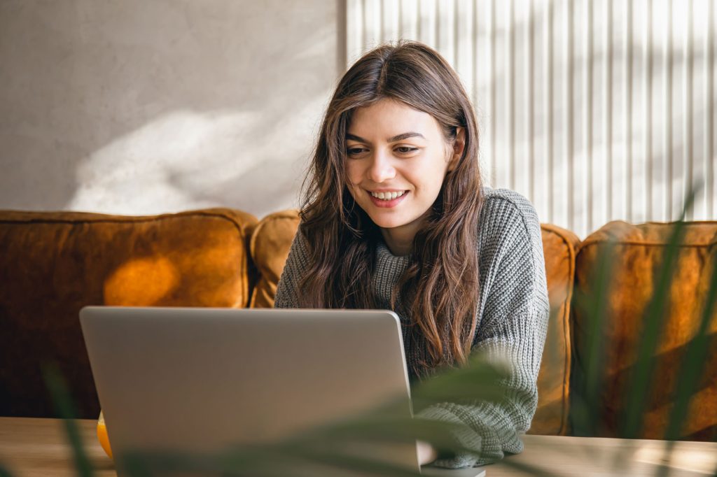 attractive young woman working laptop early morning web
