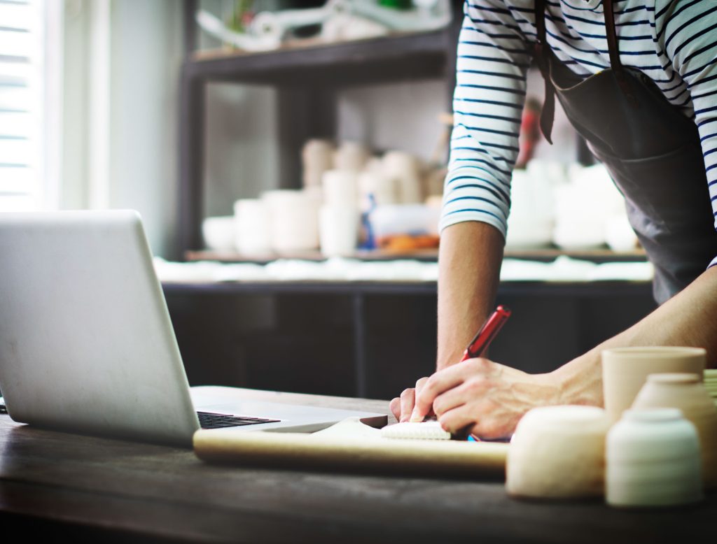 craftsman browsing laptop connection technology concept