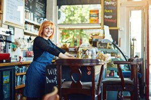 portrait waiter woman by counter cafe customer service cashier working coffee shop bistro startup small business female owner with smile store management serving barista